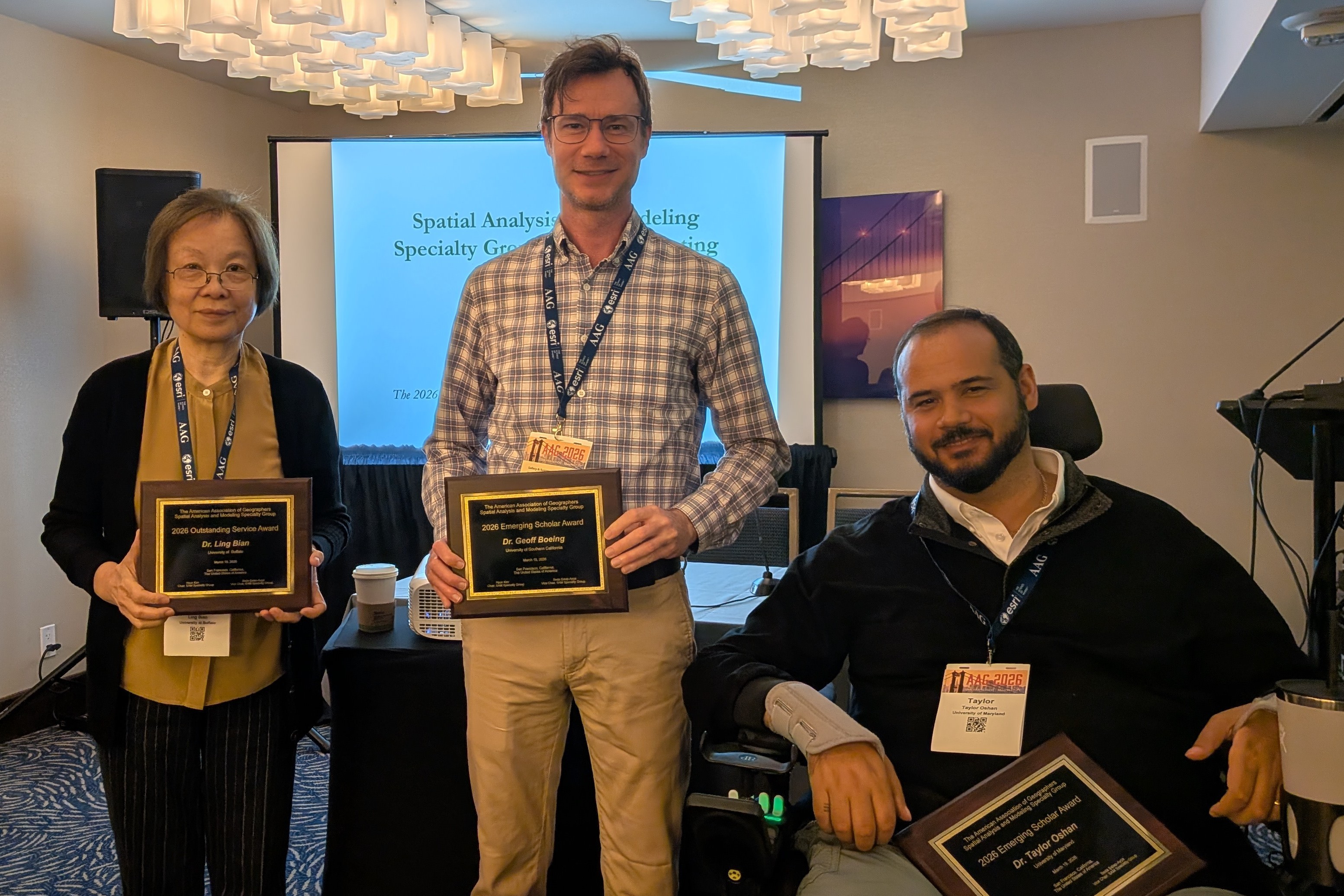 An image of the Outstanding Service & Emerging Scholar Awardees from left to right: Ling Bian, Geoff Boeing, & Taylor Oshan.
